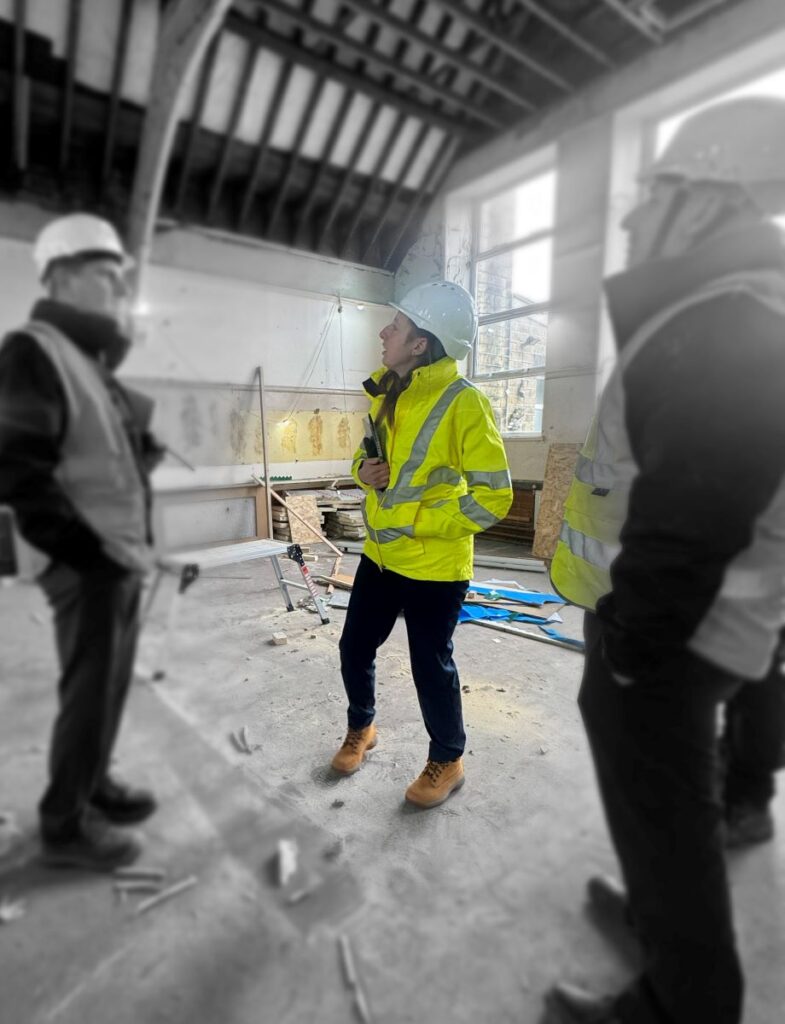 Hannah Clayton discussing construction progress with project stakeholders