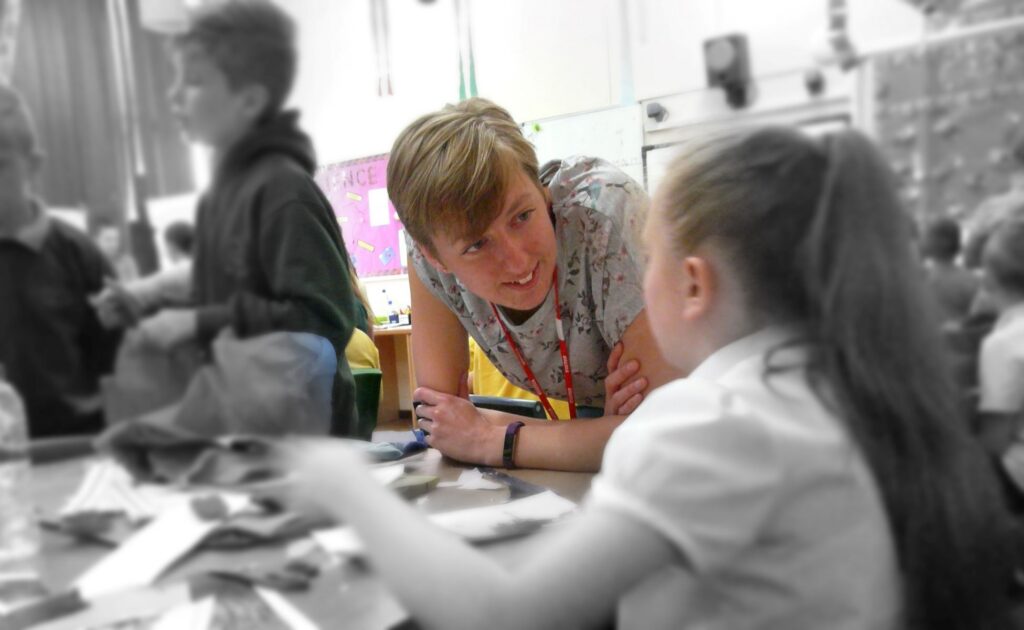 Hannah Clayton supporting pupils during an architecture workshop
