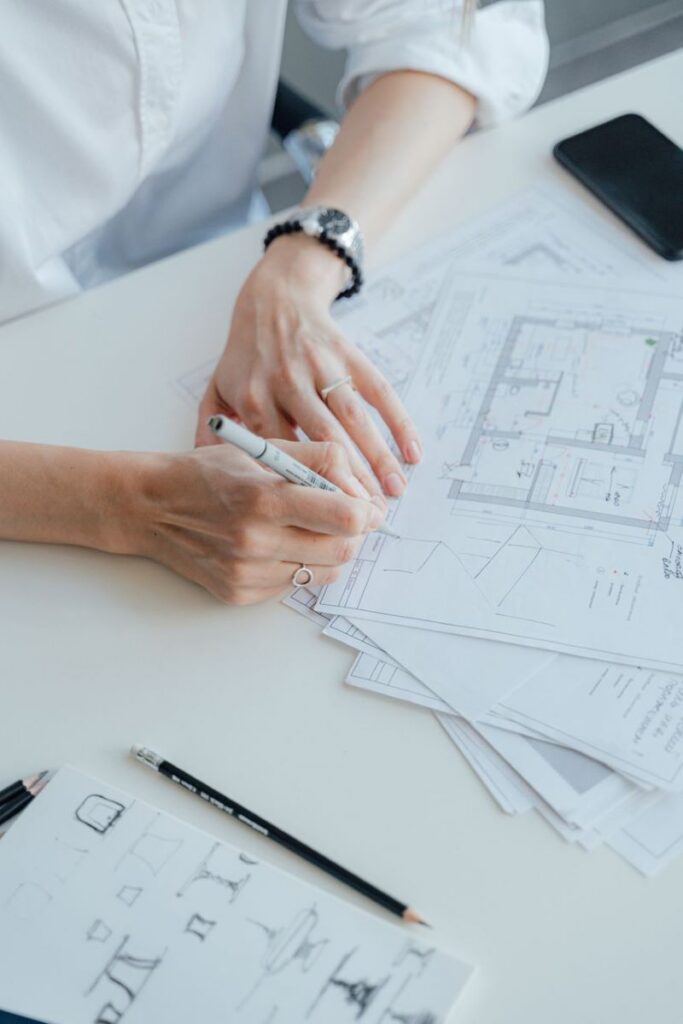 Architect reviewing architectural floor plans during the design process
